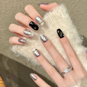 Star and moon themed press-on nails in black and silver with glitter and star ring