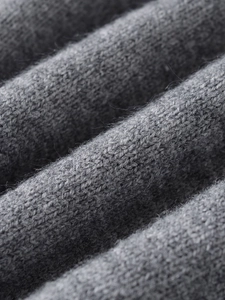 Detailed close-up showing soft grey knitted texture and premium wool fiber details