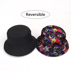 Reversible bucket hat featuring colorful skull graffiti and minimalist solid black design