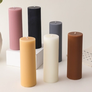 Detailed close-up showing textured vertical stripes and natural soy wax of the column candle