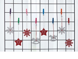 Close-up of Nordic wooden Christmas ornaments with snowflake and reindeer on wire mesh