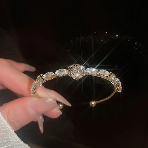 Detail view of 14k gold plated bangle with marquise zircons and rose motif