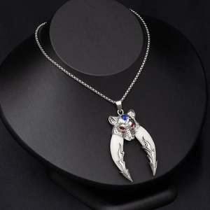 Vintage wolf head pendant necklace with white tooth accents on black display stand