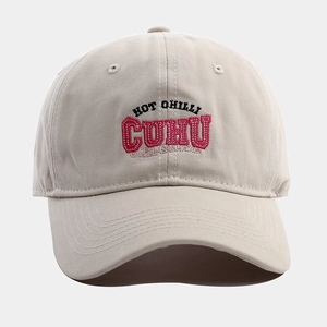 Detailed view of HOT CHILLI CUHU letter embroidery on beige soft top baseball cap