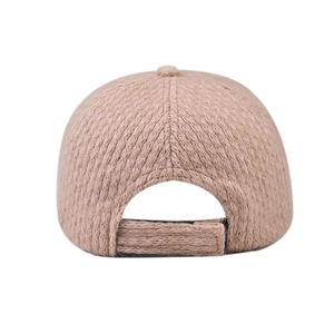 Detail of the adjustable velcro strap and plush knit texture on the back of the beige cap