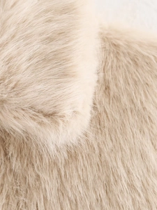 Close-up macro view showing the fluffy texture of the warm beige faux fur coat material