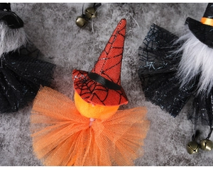 Detail of Halloween pumpkin ornament with a red spiderweb hat and orange mesh collar