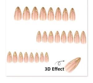 Detail view of 3D French almond press-on nails with nude base and metallic gold 3D edges