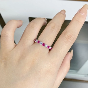 Macro detail of S925 sterling silver ring with alternating red and clear gemstones