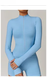 Detail of sky blue slim fit yoga jacket with thumb holes and matching sports shorts
