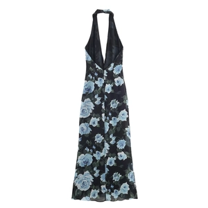 Detail of elegant black maxi dress with blue and white rose floral print and halter neck