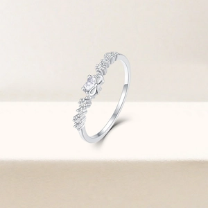 Macro shot of a 925 sterling silver bow ring with heart shaped clear gemstone