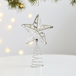 Silver star tree topper with metal spiral base on a festive pine branch background