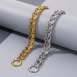 Close-up of double-layered gold and silver stainless steel Miami Cuban link bracelets