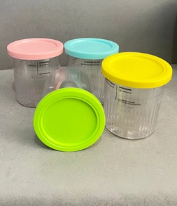 Detailed view of four colorful storage containers with scales for Ninja NC500 series