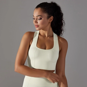Detail of light green seamless sports bra featuring breathable knit texture and wide straps