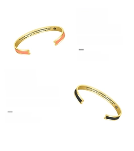 Detail view of gold-plated stainless steel cuff bangles with enamel and inner engraving