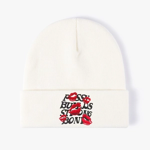 Off-white knit beanie featuring red lip embroidery and Buds Strong Bones text
