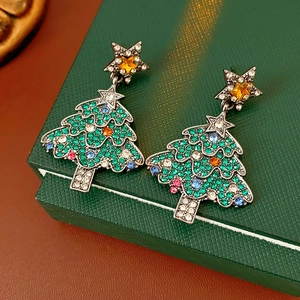 Detailed close-up of vintage star Christmas tree earrings with colorful rhinestones