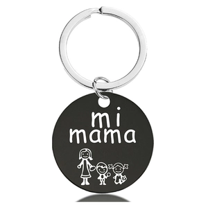 Close-up of black metal keychain with engraved mi mama text and mother figures