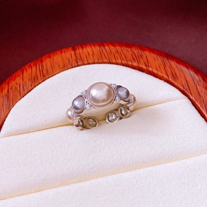 Detail view of multi-color pearls and pavé diamonds on a vintage open ring design