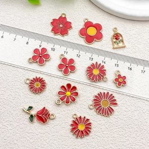 Red flower and rose enamel charms for DIY jewelry making shown with metric ruler