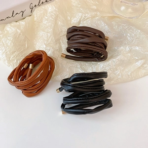 Three-piece faux leather hair ties in black brown and caramel with golden metal tips
