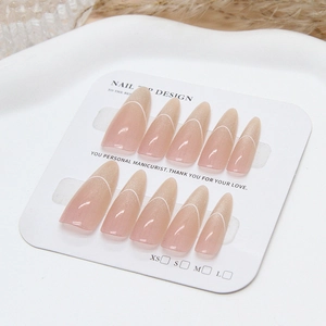 Handmade nude pink cat eye press-on nails with white 3D lines on a display card