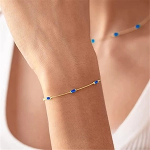Detail of 925 silver gold bracelet with three sparkling blue rectangular gemstones
