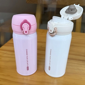 Detail showing pink and white stainless steel vacuum flasks with spring lids and safety locks