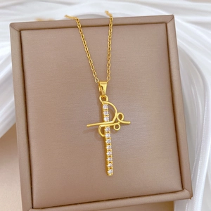 Elegant gold titanium steel necklace with a hollow sparkling cross pendant on silk