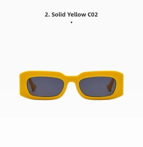 Detail view of bold yellow rectangular sunglasses frames with dark grey tinted lenses