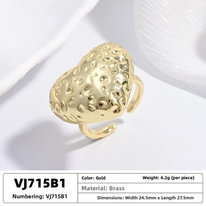 Macro shot of heart-shaped brass ring with hammered texture and adjustable open band
