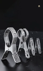 Macro detail of waterproof stainless steel laundry pegs in various sizes on dark background