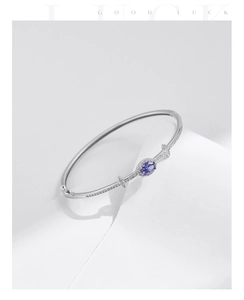 Macro shot of S925 silver bracelet featuring oval sapphire centerpiece and pavé diamonds