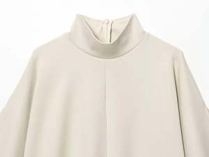 Macro shot of apricot knit top neck with invisible back zipper and twill texture