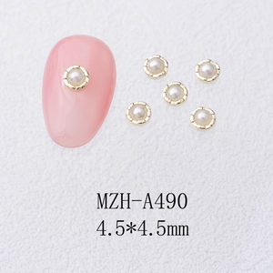 Detailed view of 4.5mm gold-rimmed pearl flower charms for DIY nail art and design