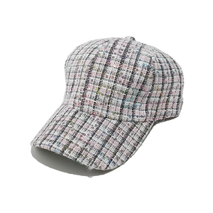 Macro detail of multicolored tweed fabric with sparkling sequins on the fashion baseball cap