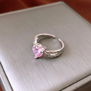 Macro shot of pink heart-shaped crystal ring with silver pavé cubic zirconia details