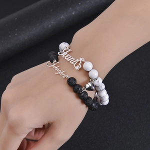 Detail shot of magnetic attraction heart charm on white turquoise and lava stone bracelets