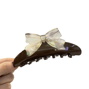 French vintage acetate hair claw clip with colorful iridescent bow design on white background
