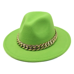Macro detail of wool-textured neon green fedora hat with chunky gold metal chain link