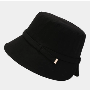 Classic black cotton bucket hat with elegant gold metal trim detail on simple ribbon