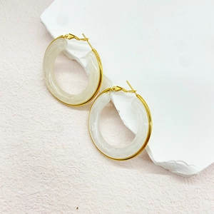 Detail of 18K gold stainless steel hoop earrings with white marble resin texture inlay