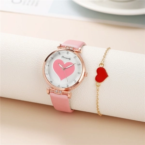 Detail of pink leather watch with heart pattern and matching gold heart charm bracelet