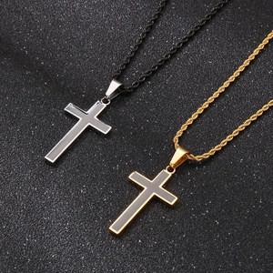 Silver and gold cross pendants with rope chains on a textured black background