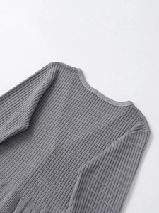 Detailed macro view of the grey ribbed knit fabric texture and high-quality edge stitching