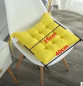 Detail view of bright yellow square chair cushion with 9-hole quilting and ties