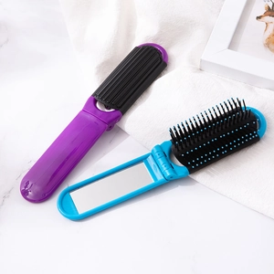 Macro detail of blue and purple folding travel hairbrush with integrated mirror