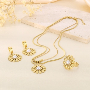 Elegant gold sunflower jewelry set with pearls including necklace, earrings and ring